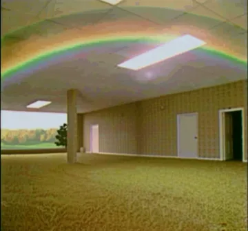 Empty carpeted room with rainbow light.