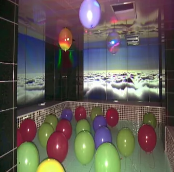 Balloons in a glowing arcade room.