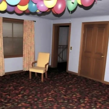 Balloons above two closed wooden doors.