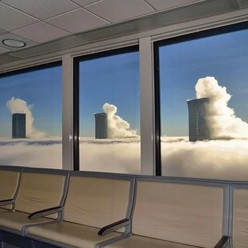 Waiting chairs beside windows overlooking towers.