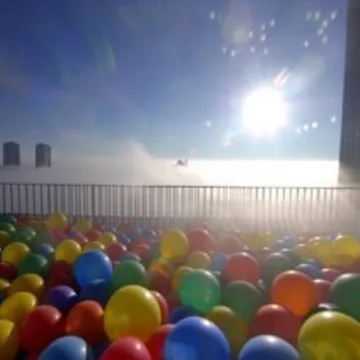 Ball pit beneath a sparkling blue sky.