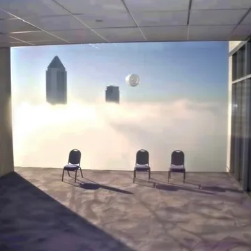 Waiting chairs in a room filled with sky.