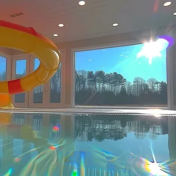 Indoor pool lit with rainbow reflections.
