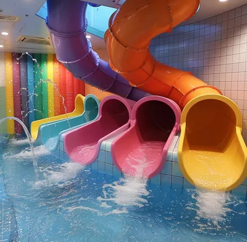 Colorful tube slides pouring into a pool.