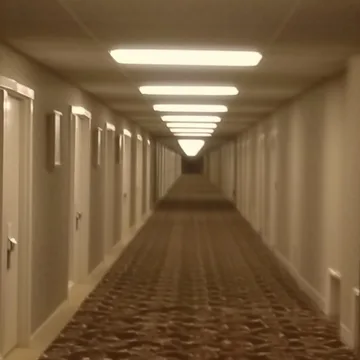 Long beige hallway with repeating doors.