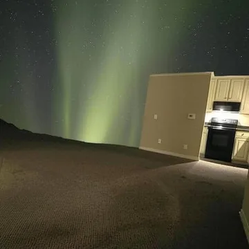 Green light across an empty room.