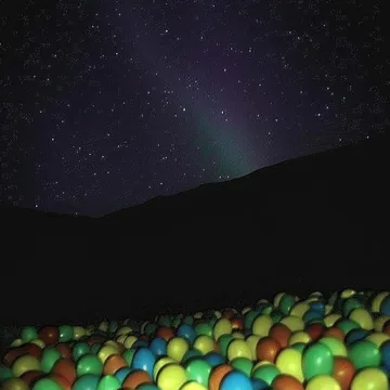 Ball pit beneath a star-filled sky.