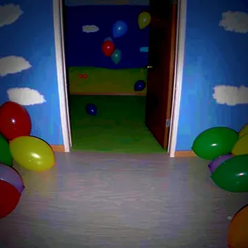 Balloons in a room painted with clouds.