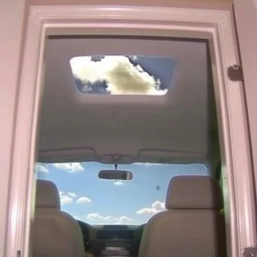 Sky visible through a car window and sunroof.