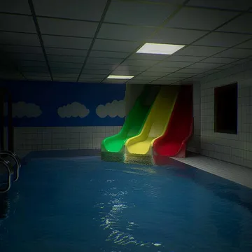 Small slides above a dark indoor pool.