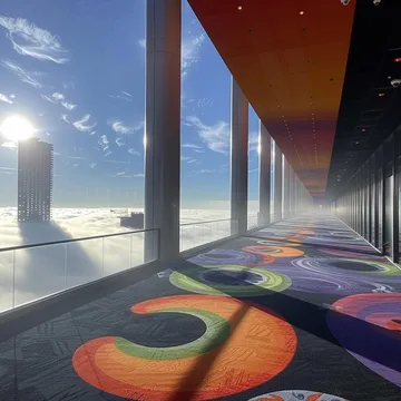 Colorful carpet beside windows above the clouds.