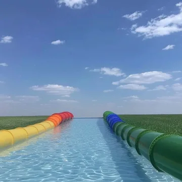 Two long water slides beneath an open blue sky.