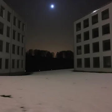 Apartment courtyard beneath a night sky.