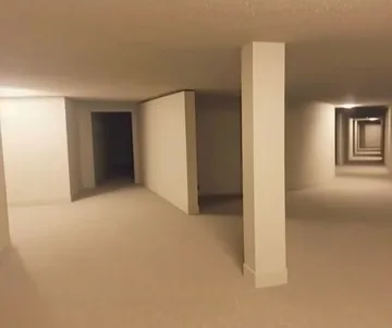 Empty basement with beige pillars.