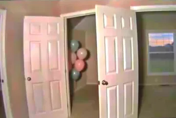 Open double doors with balloons beyond.