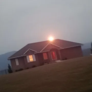 Low house beneath a pale sunset.