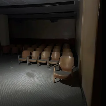 Rows of seats in a dark theater.