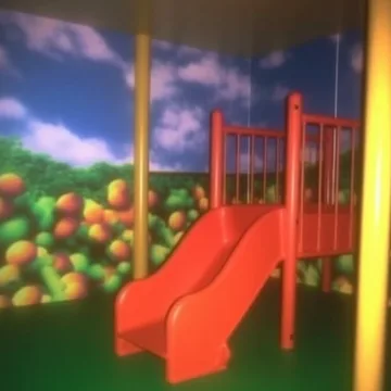 Red playground slide in a room painted with clouds.