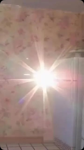 Sunburst across floral wallpaper.