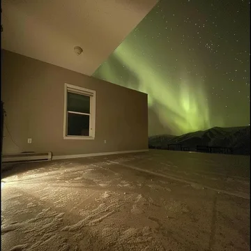 Green light across the walls of an empty room.