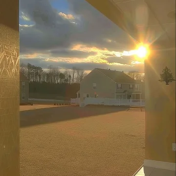 Sunset through a wide window in an empty room.