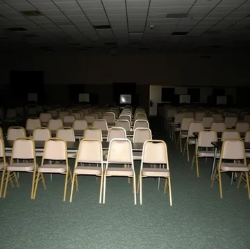 Rows of chairs under a low ceiling.