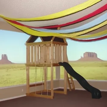 Playground under streamers overlooking the desert.