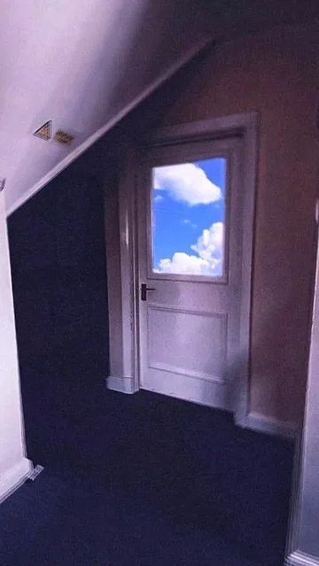 Doorway to the sky beside a dark staircase.
