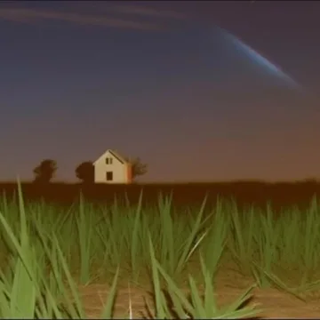 Small house beneath a rainbow at dusk.