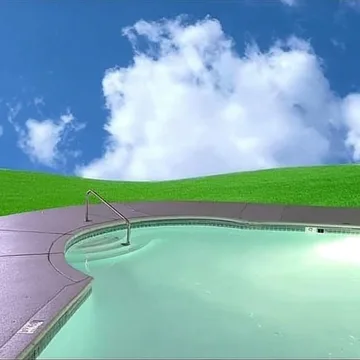 Circular pool in a green hillside.