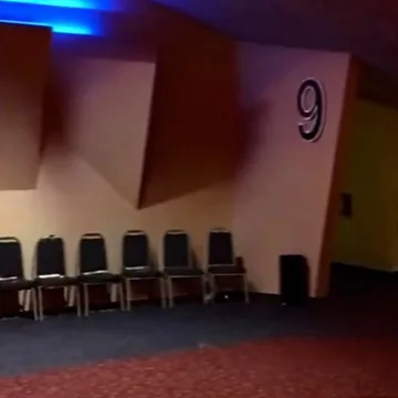 Row of chairs against a wall marked with a number.