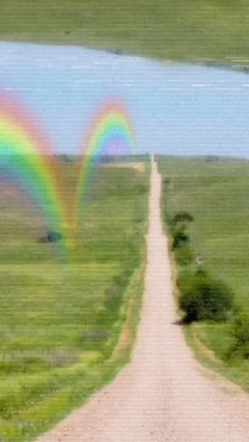 Long garden path beneath a rainbow.