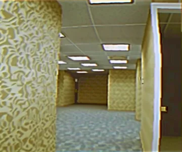Yellow patterned walls in an empty corridor.
