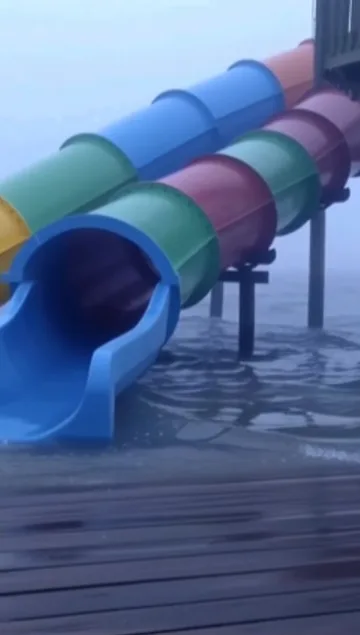 Colorful tube slides on a wooden deck.