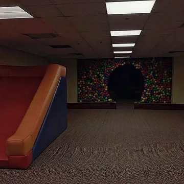 Small playground beside a dark circular tunnel.