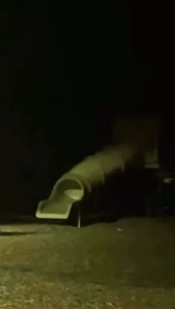 Small slide illuminated in a dark room.