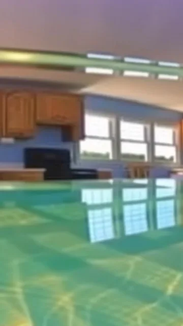 Turquoise water reflecting a quiet kitchen.
