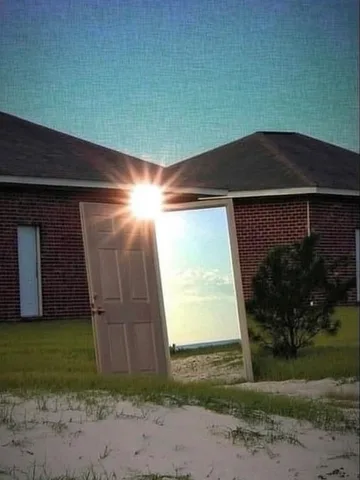 Door glowing in front of a house at night.
