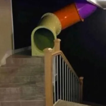 Play tunnel beside a stair railing.