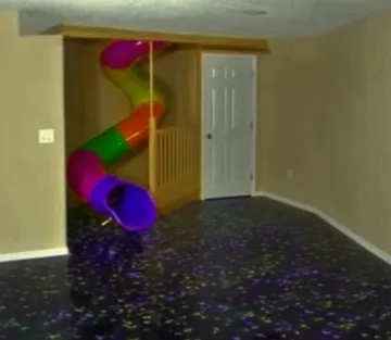 Colorful tube slide on a patterned carpet.