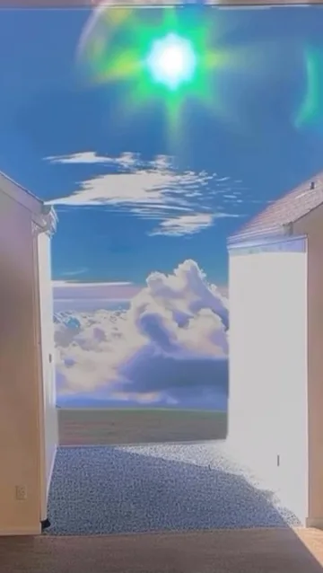 Doorway to clouds under a bright blue sky.