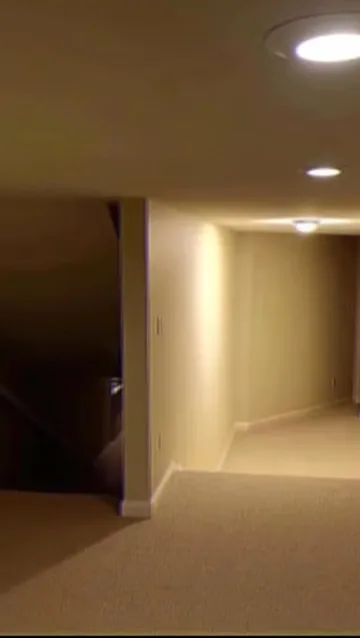 Light on a bare beige corner.