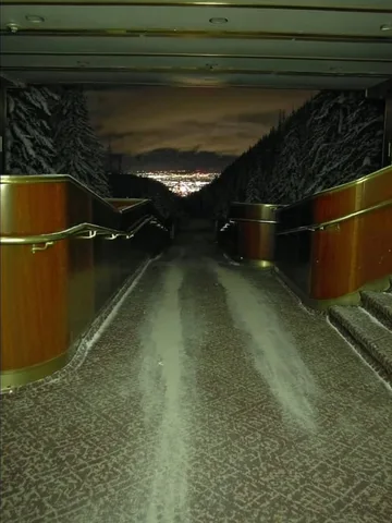 Dark symmetrical corridor with yellow pillars.