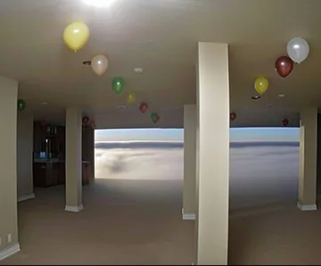 Balloons above pillars in an empty room.