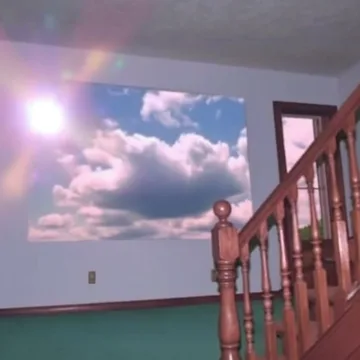 Pink staircase beneath a sunlit cloud ceiling.