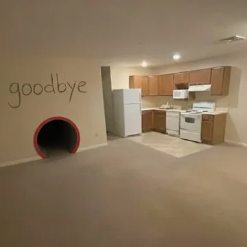 Circular tunnel beside an empty kitchen.