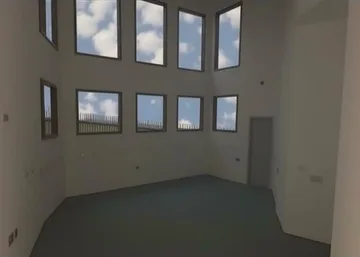 Tall empty room with rows of windows.