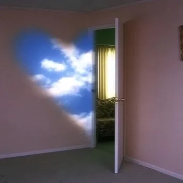 Cloud-shaped light beside a door in a pink room.
