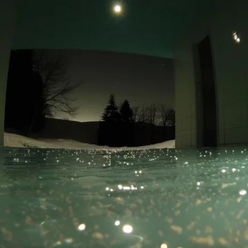 Moonlight reflected in water beneath an arch.