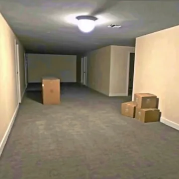 Boxes in an empty gray room.